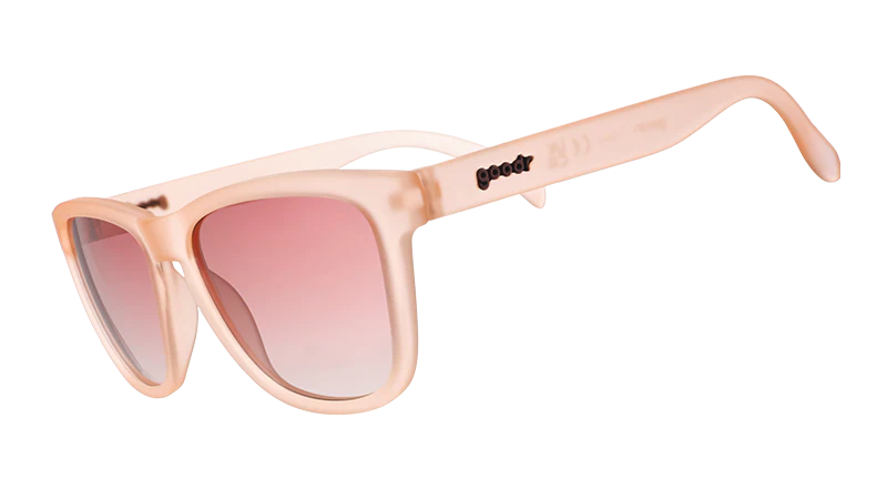 Product close up of pink square-framed sunglasses with pink gradient lenses.