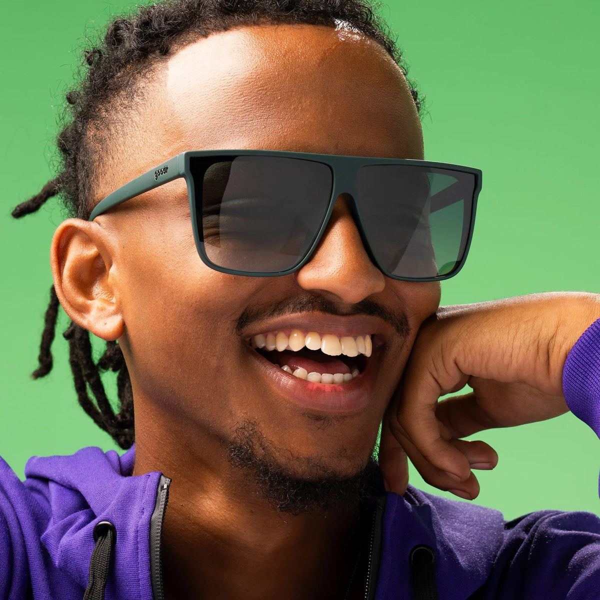 Fit and style showcase of dark green oversized, flat-top sunglasses with gradient lenses to improve ground visibility. No slip, no bounce, all polarised.